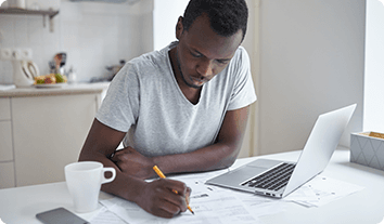 a man writing on a laptop