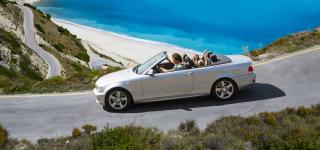 Driver driving a convertible on a scenic road