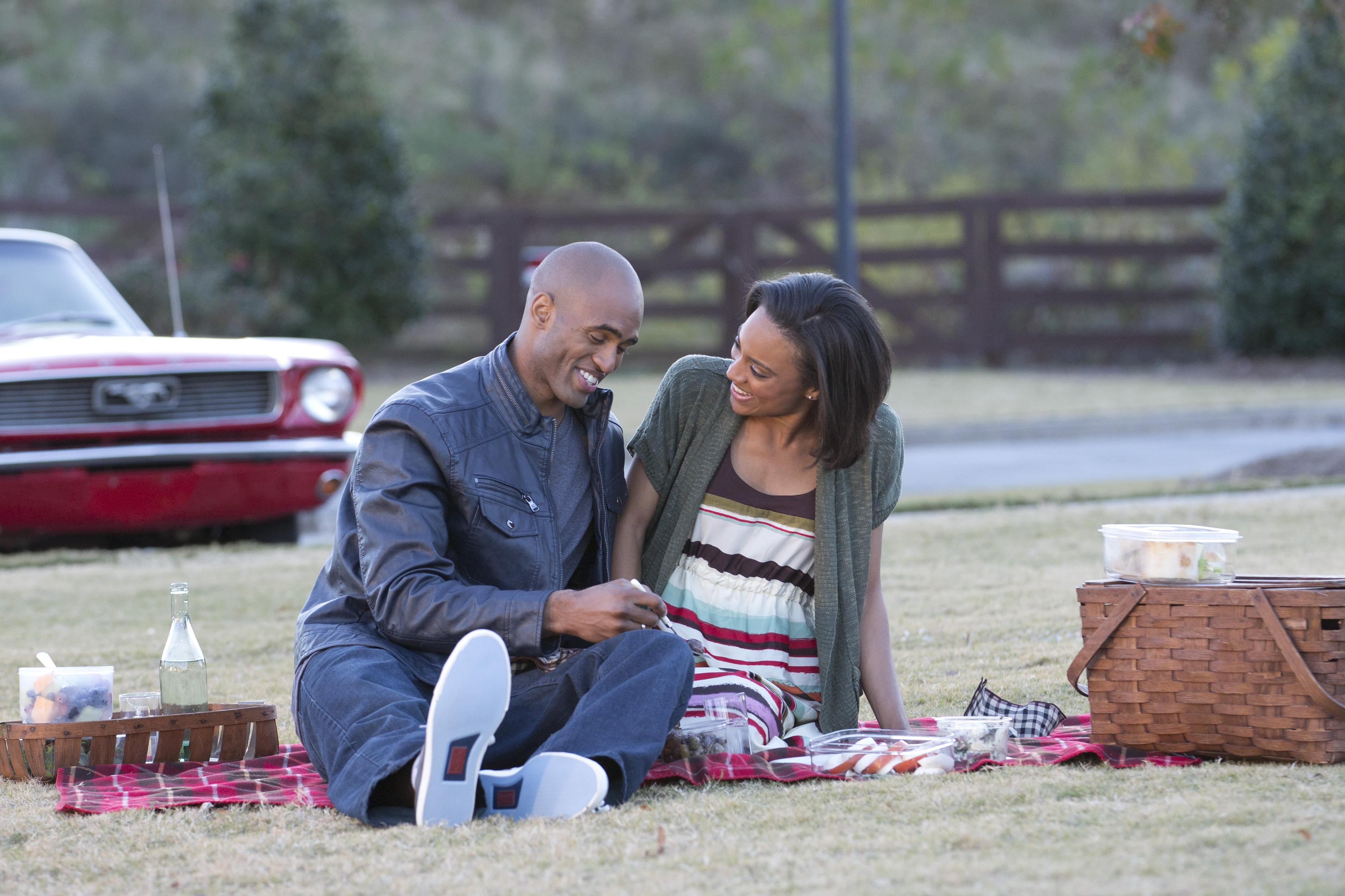 a man and woman sitting on the ground